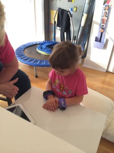 Preparing for preschool.  Learning 'quiet hands' while watching Zac Effron (her favorite).